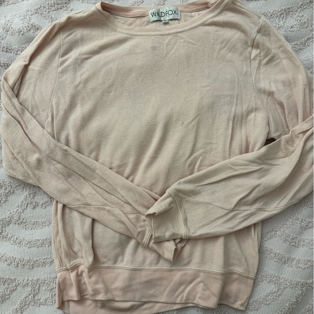 Baby pink wild fox top. Size medium. Has blue detergent stains